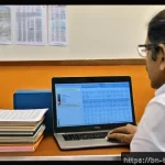Home 21 통역사 현장 에티켓 - A professional Bengali translator sitting at a modern desk filled with bilingual dictionaries, a lap...